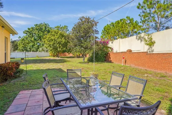 a view of a swimming pool with a lawn chairs and a table