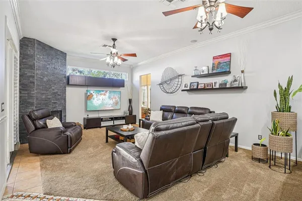 a living room with furniture a chandelier and a window