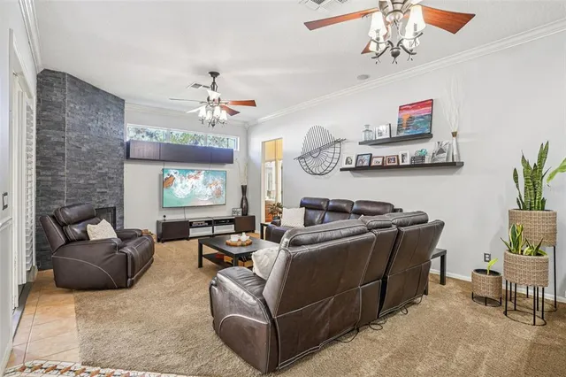 a living room with furniture a chandelier and a window