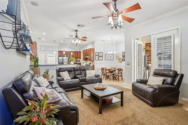 a living room with furniture ceiling fan and a rug