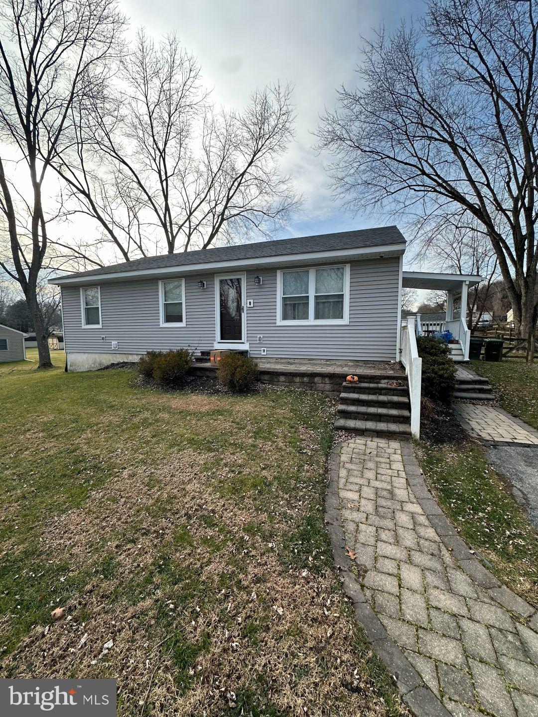 a backyard of a house with yard and outdoor seating