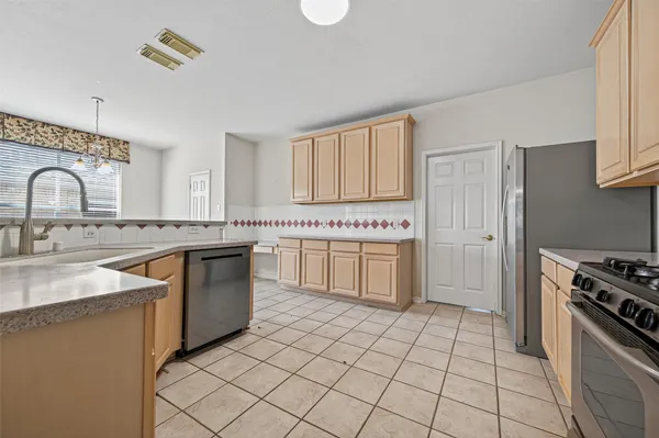 a kitchen with a stove a sink and a refrigerator