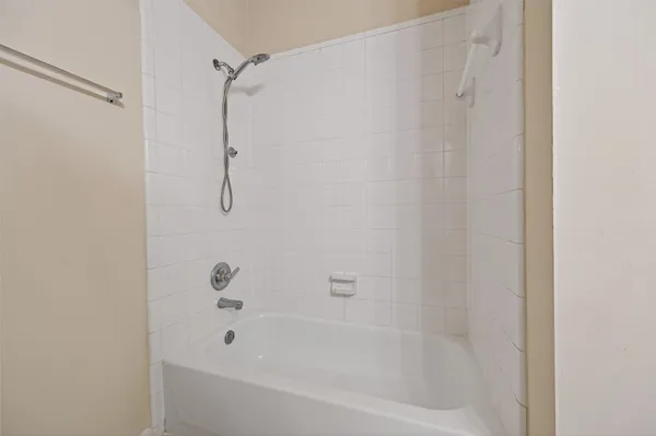 a bathroom with a shower and a bath tub