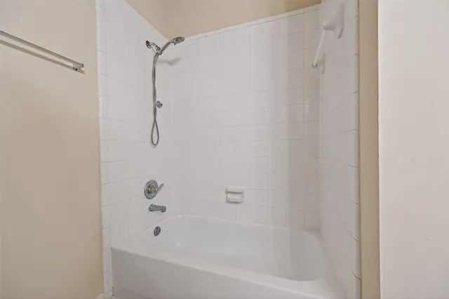 a bathroom with a shower and a bath tub