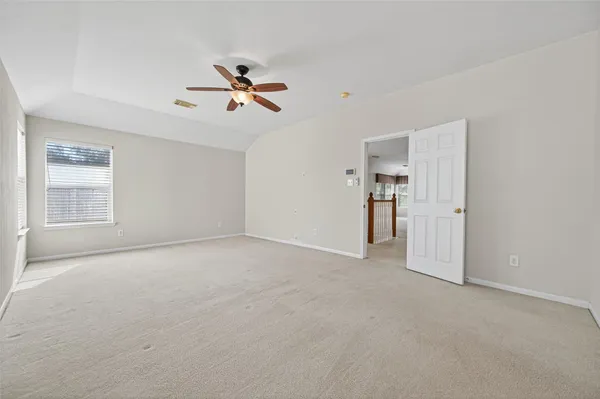 a view of empty room with ceiling fan