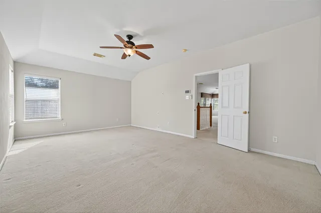 a view of empty room with ceiling fan