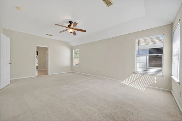 a view of a livingroom with a ceiling fan and window