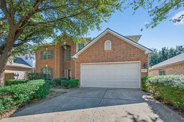 a front view of house with yard and trees