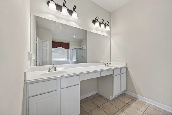 a bathroom with a double vanity sink mirror and