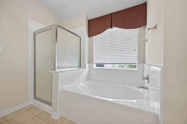 a bathroom with a bathtub and a shower