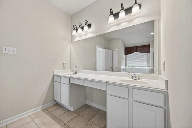 a bathroom with a double vanity sink mirror and