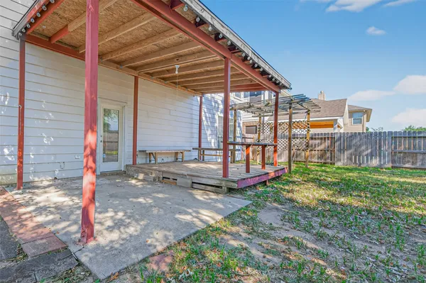 a view of a backyard with wooden fence