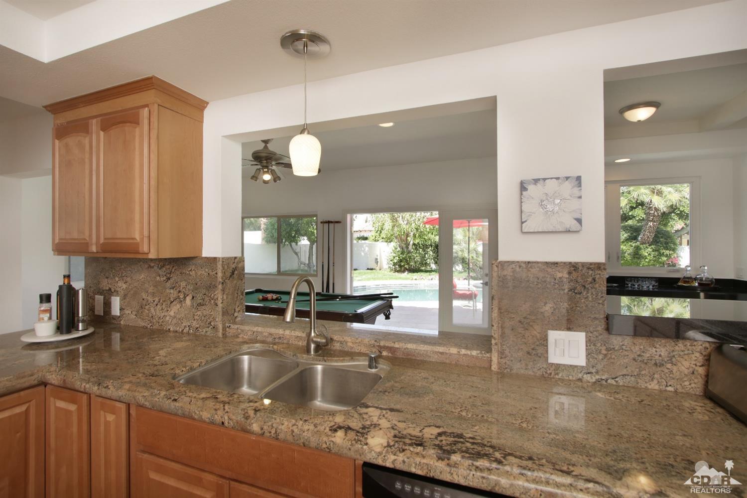 75570 Fairway Drive Indian Wells, CA 92210 - Photo 11 of 38 a kitchen with a sink a counter top space and cabinets