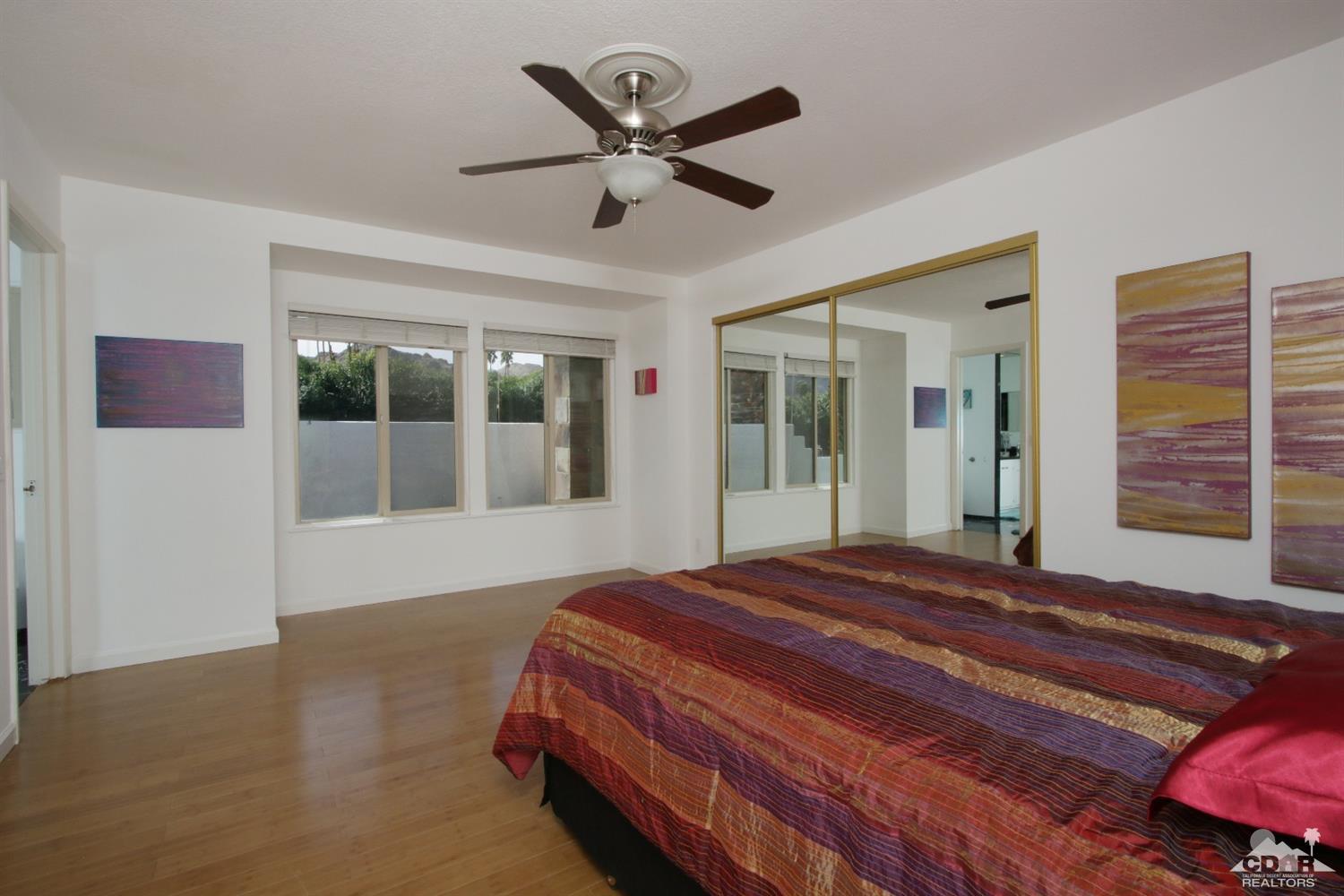 75570 Fairway Drive Indian Wells, CA 92210 - Photo 20 of 38 a bedroom with a large bed and a large window