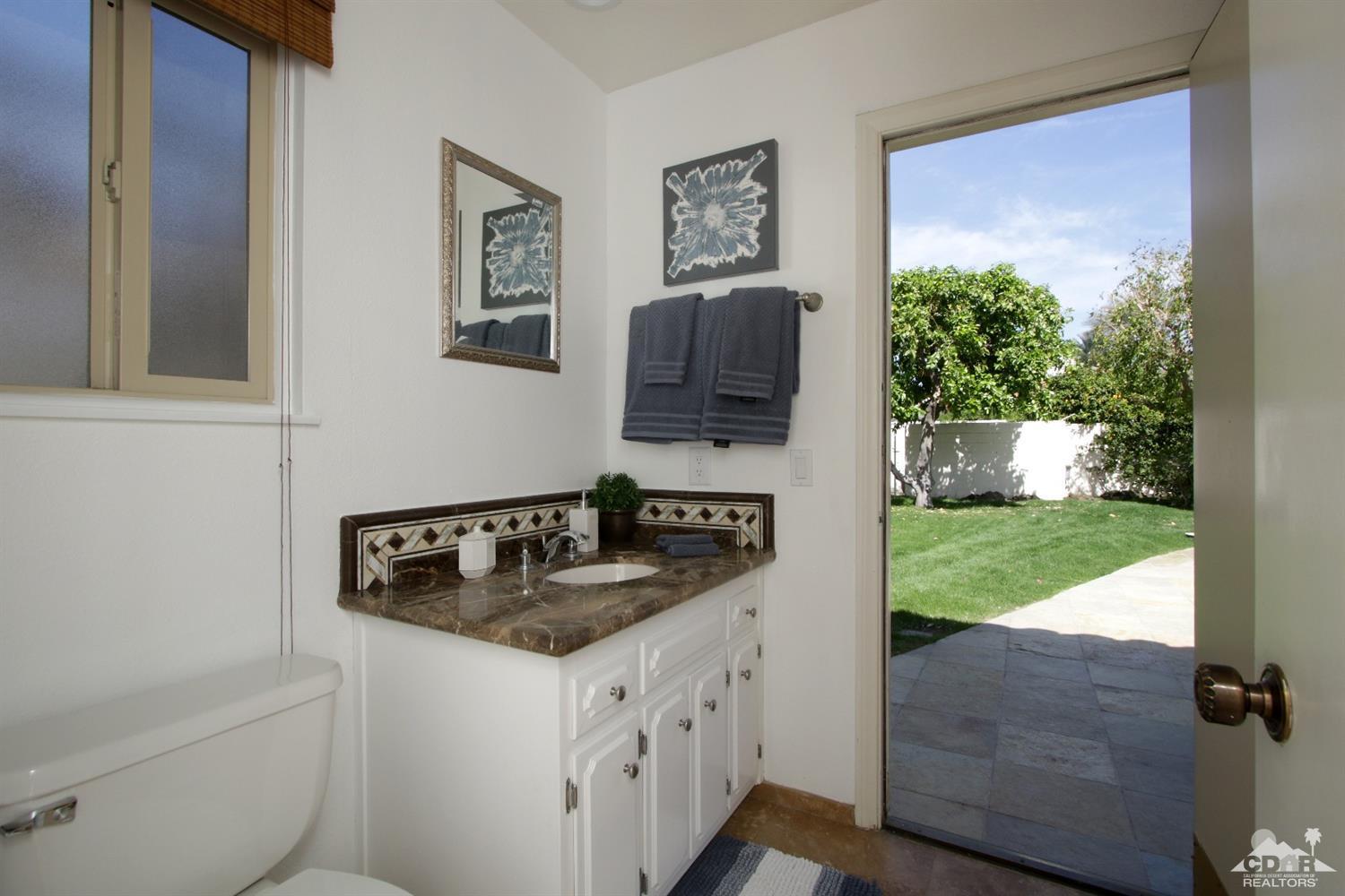 75570 Fairway Drive Indian Wells, CA 92210 - Photo 25 of 38 a bathroom with a granite countertop sink and a mirror