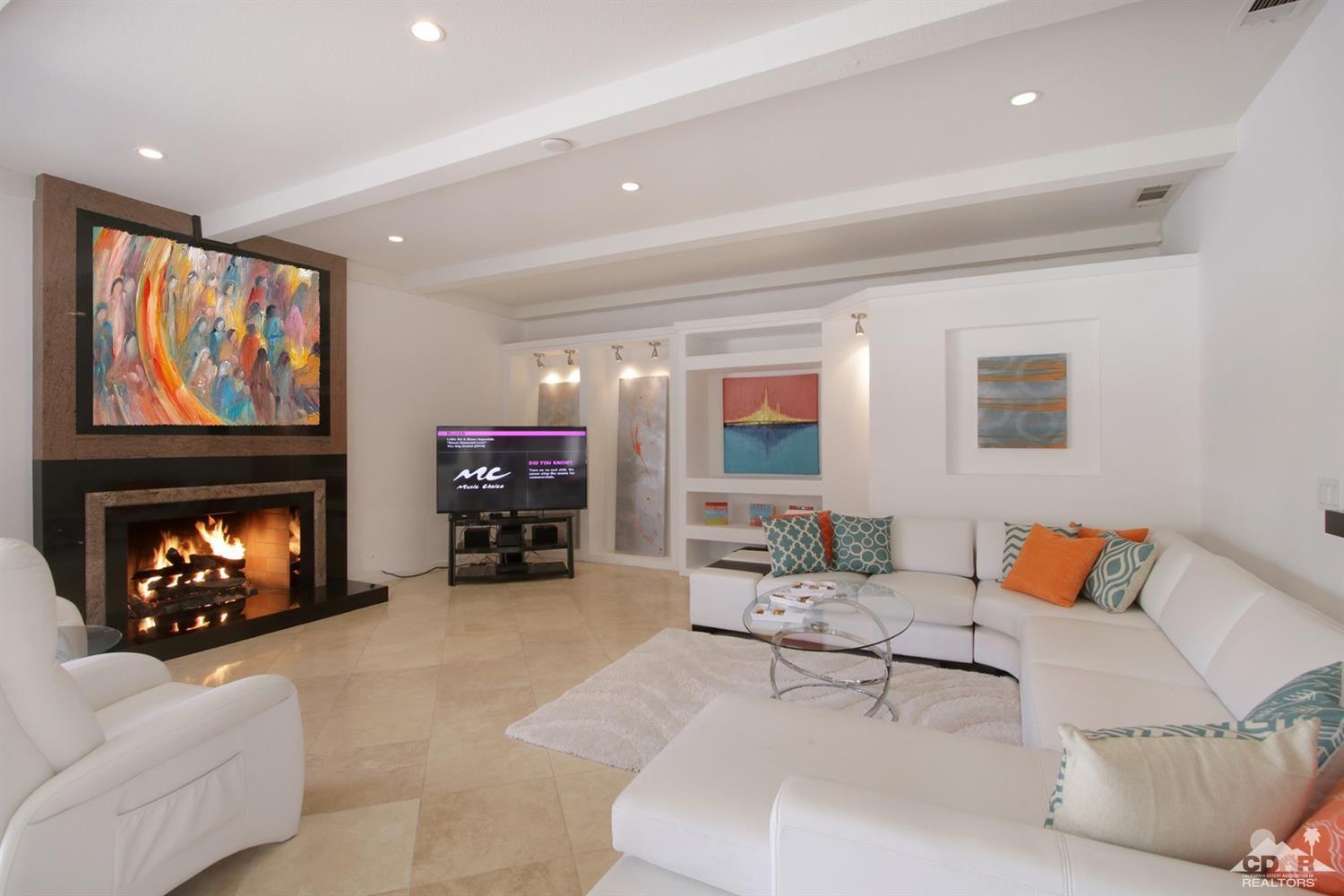 75570 Fairway Drive Indian Wells, CA 92210 - Photo 4 of 38 a living room with furniture and a fireplace with chair