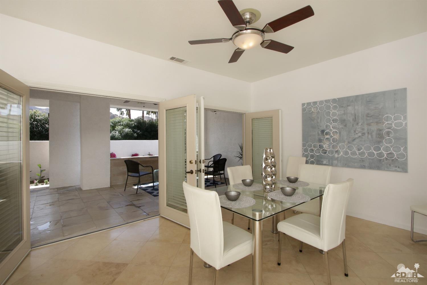 75570 Fairway Drive Indian Wells, CA 92210 - Photo 7 of 38 a view of a dining room with furniture and a chandelier fan