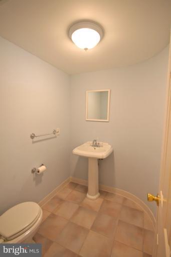 13007 Middlevale Lane Silver Spring, MD 20906 - Photo 15 of 30 a bathroom with a sink a toilet and a mirror
