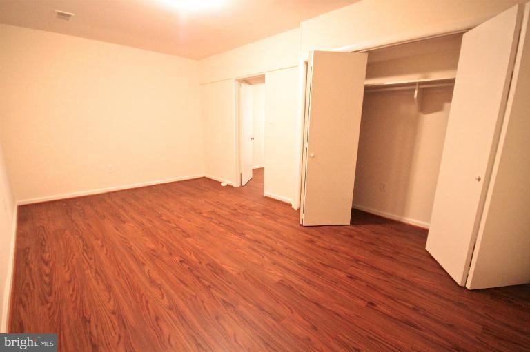 13007 Middlevale Lane Silver Spring, MD 20906 - Photo 19 of 30 an empty room with wooden floor and closet