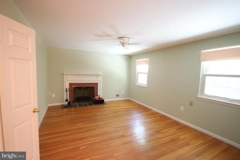 13007 Middlevale Lane Silver Spring, MD 20906 - Photo 20 of 30 an empty room with windows and a fireplace