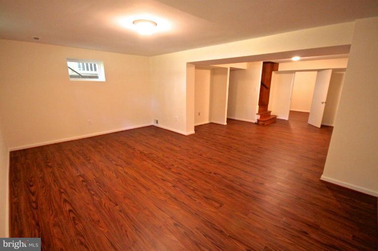 13007 Middlevale Lane Silver Spring, MD 20906 - Photo 22 of 30 an empty room with wooden floor and windows