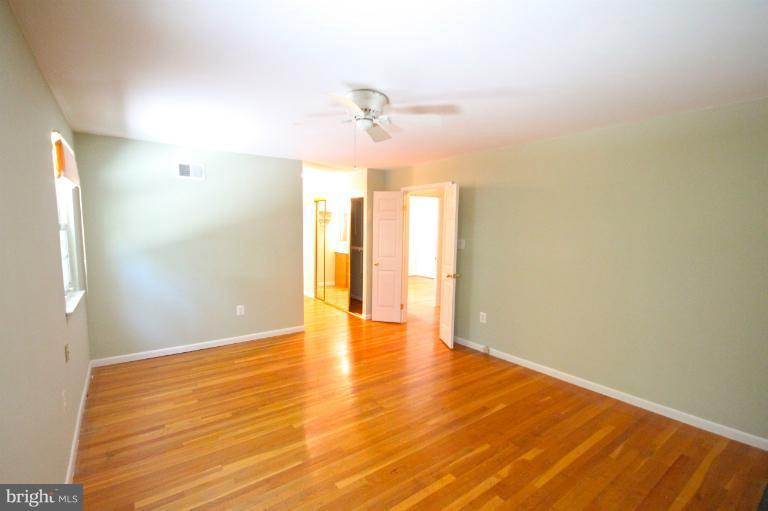13007 Middlevale Lane Silver Spring, MD 20906 - Photo 23 of 30 a view of an empty room with window and wooden floor