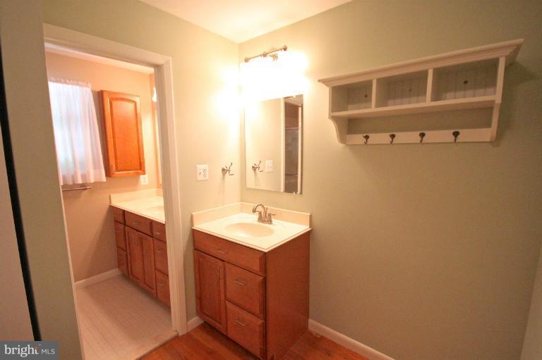 13007 Middlevale Lane Silver Spring, MD 20906 - Photo 26 of 30 a bathroom with a sink a mirror and a shower