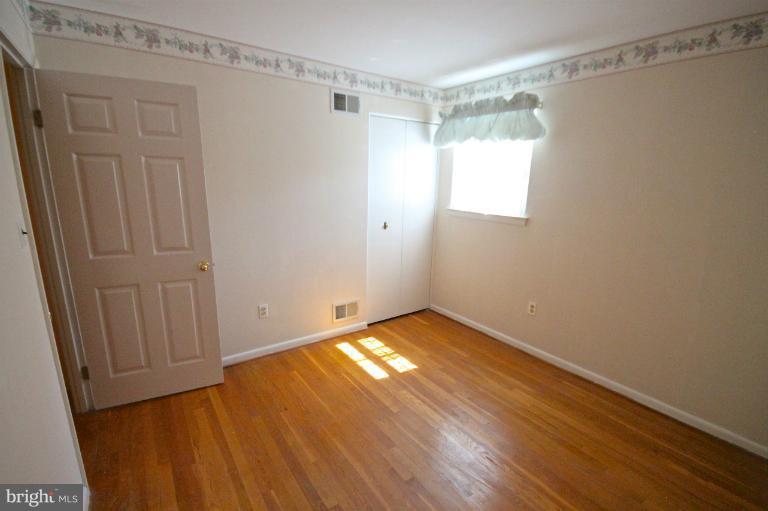 13007 Middlevale Lane Silver Spring, MD 20906 - Photo 28 of 30 a view of an empty room with wooden floor and a window