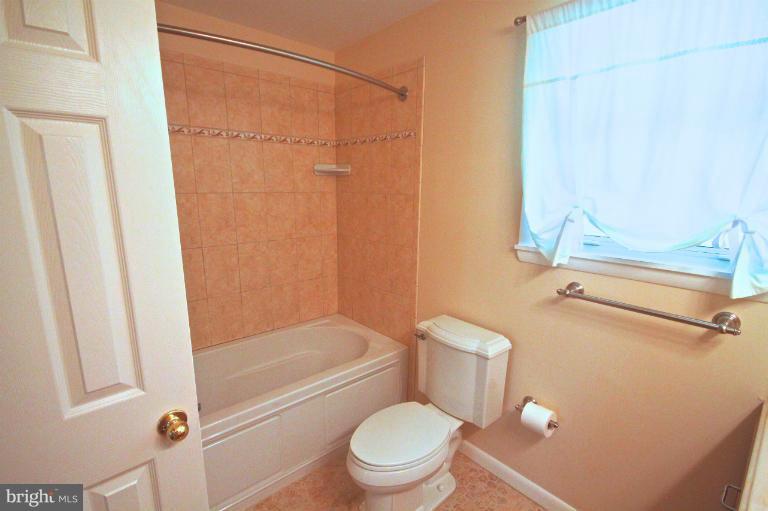 13007 Middlevale Lane Silver Spring, MD 20906 - Photo 29 of 30 a bathroom with a granite countertop bathtub shower sink vanity and toilet