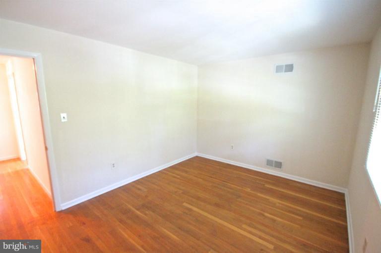 13007 Middlevale Lane Silver Spring, MD 20906 - Photo 30 of 30 an empty room with wooden floor
