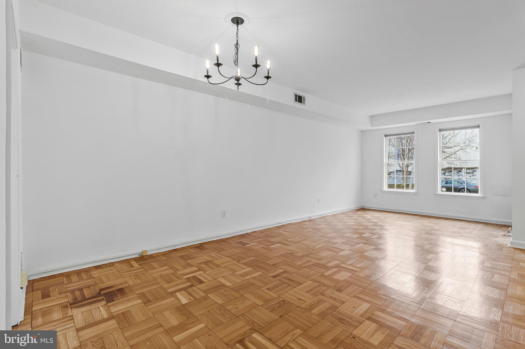 123 E Street Southeast Washington, DC 20003 - Photo 11 of 42 a view of an empty room with chandelier and a window