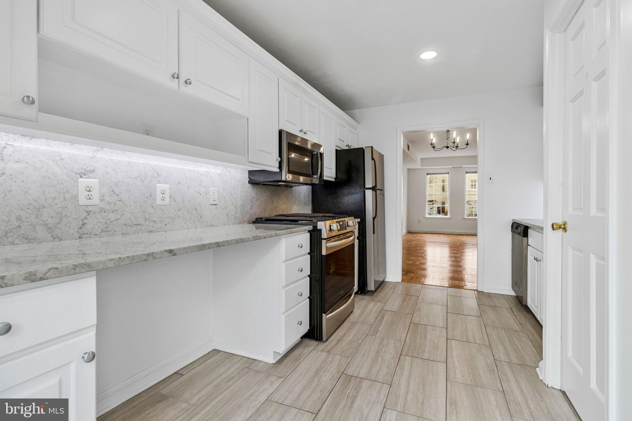 123 E Street Southeast Washington, DC 20003 - Photo 15 of 42 a kitchen with granite countertop a refrigerator and a stove