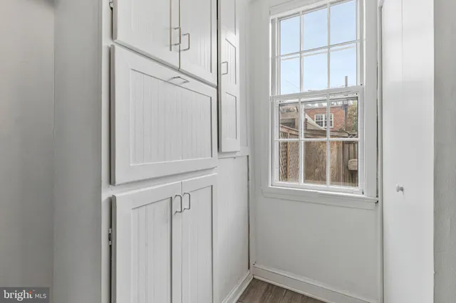 a view of a hallway with wooden floor and entryway
