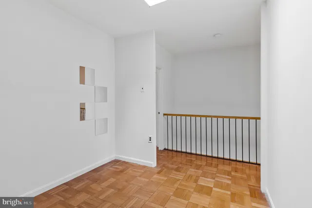 a view of a hallway with a chandelier fan and entryway