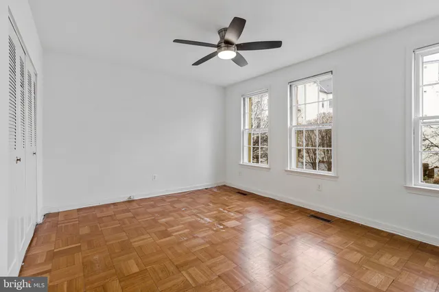a view of a brick house with many windows
