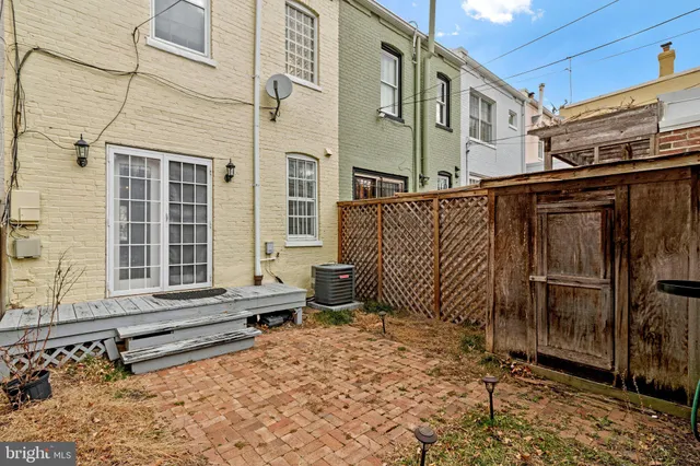 a view of a brick house with many windows
