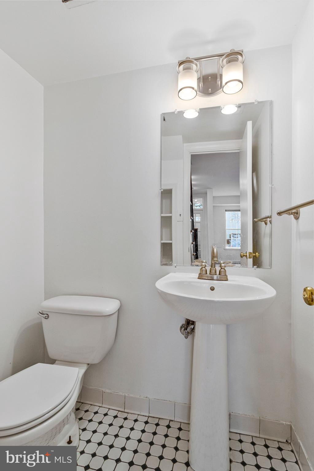 123 E Street Southeast Washington, DC 20003 - Photo 6 of 42 a bathroom with a sink a toilet and mirror