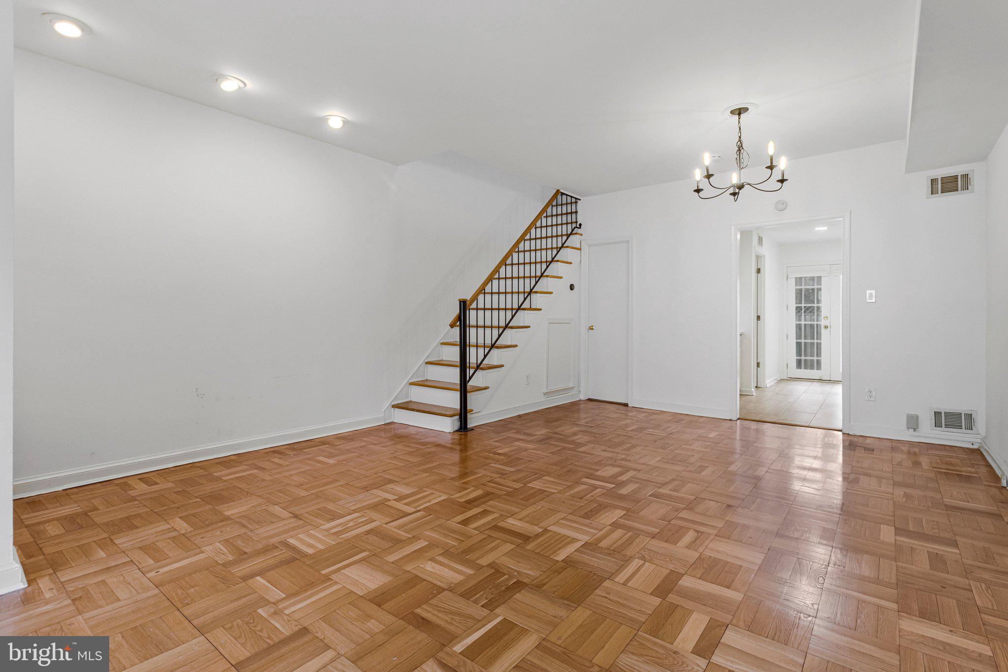 123 E Street Southeast Washington, DC 20003 - Photo 9 of 42 a view of an empty room with stairs and chandelier fan
