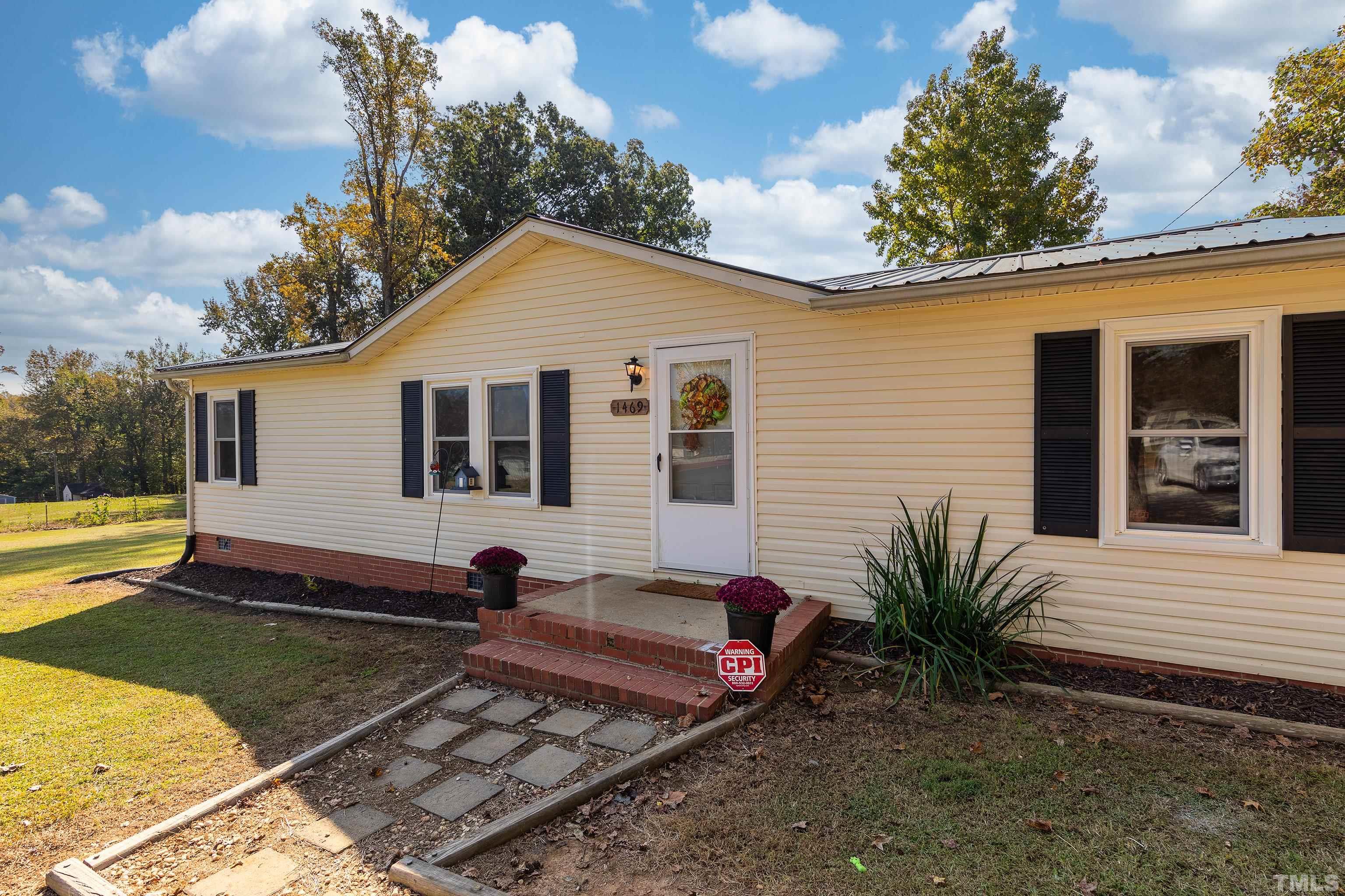 1469 Semora Road Roxboro, NC 27574 - Photo 1 of 22 a view of a house with backyard and sitting area