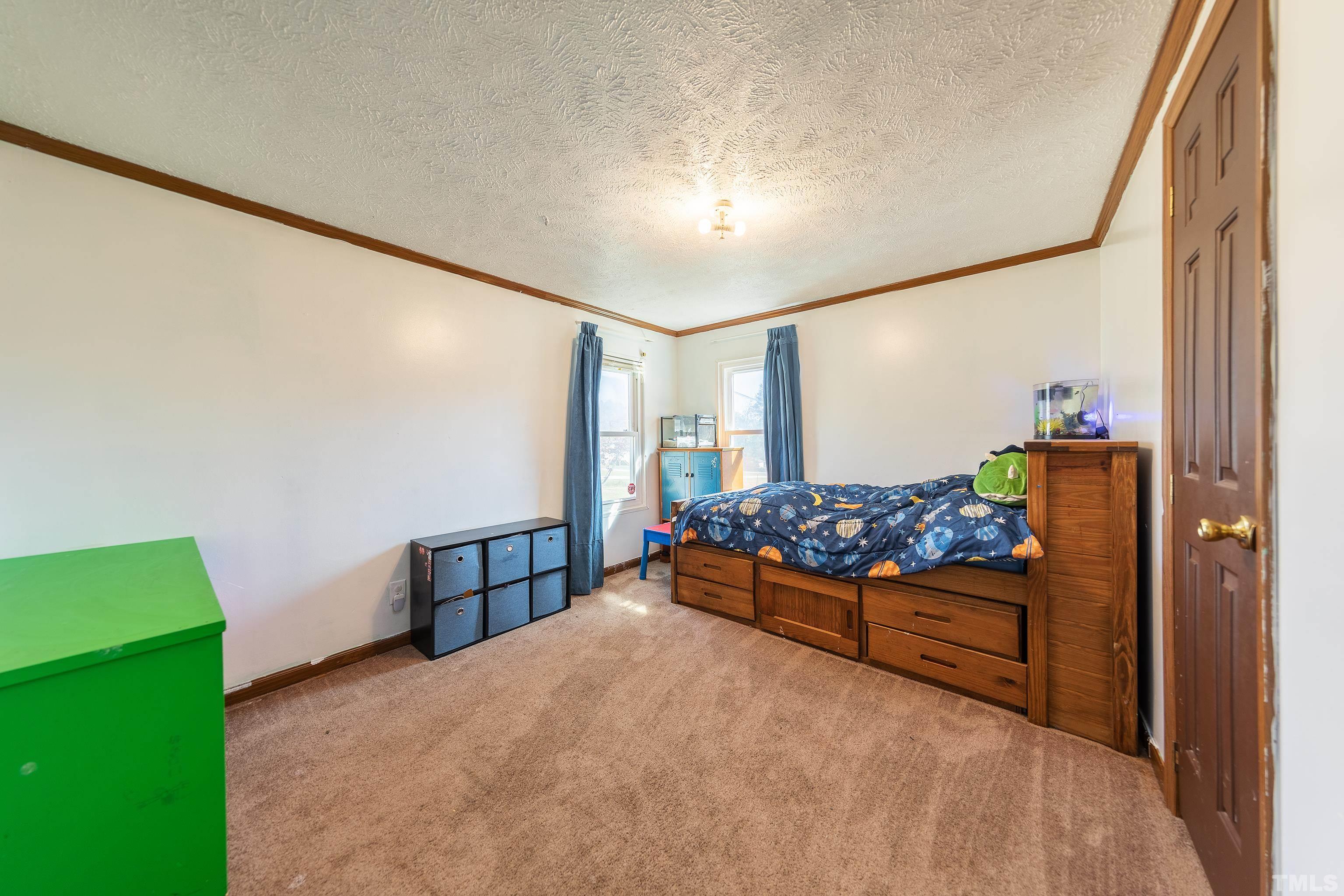 1469 Semora Road Roxboro, NC 27574 - Photo 14 of 22 a bedroom with furniture and window