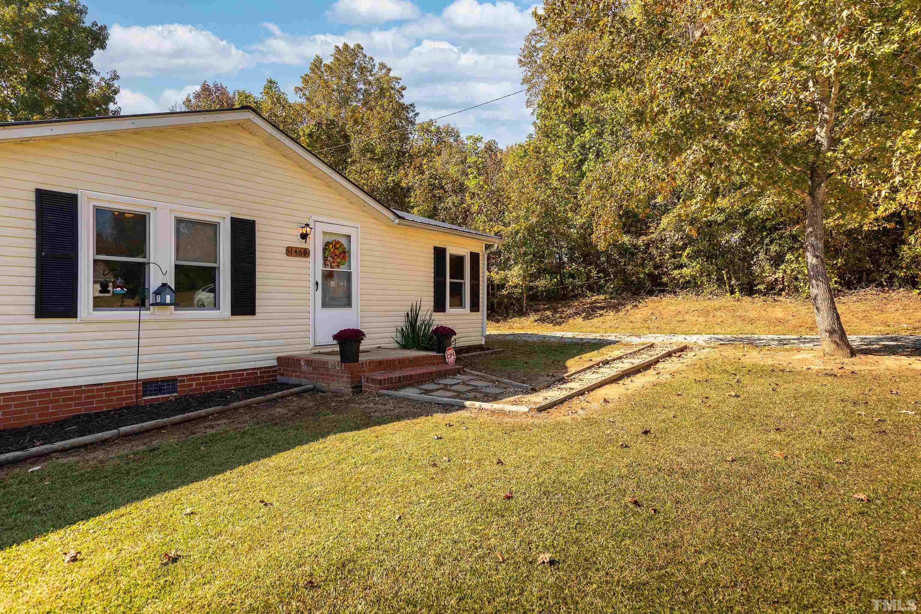 1469 Semora Road Roxboro, NC 27574 - Photo 2 of 22 a view of a house with backyard and trees