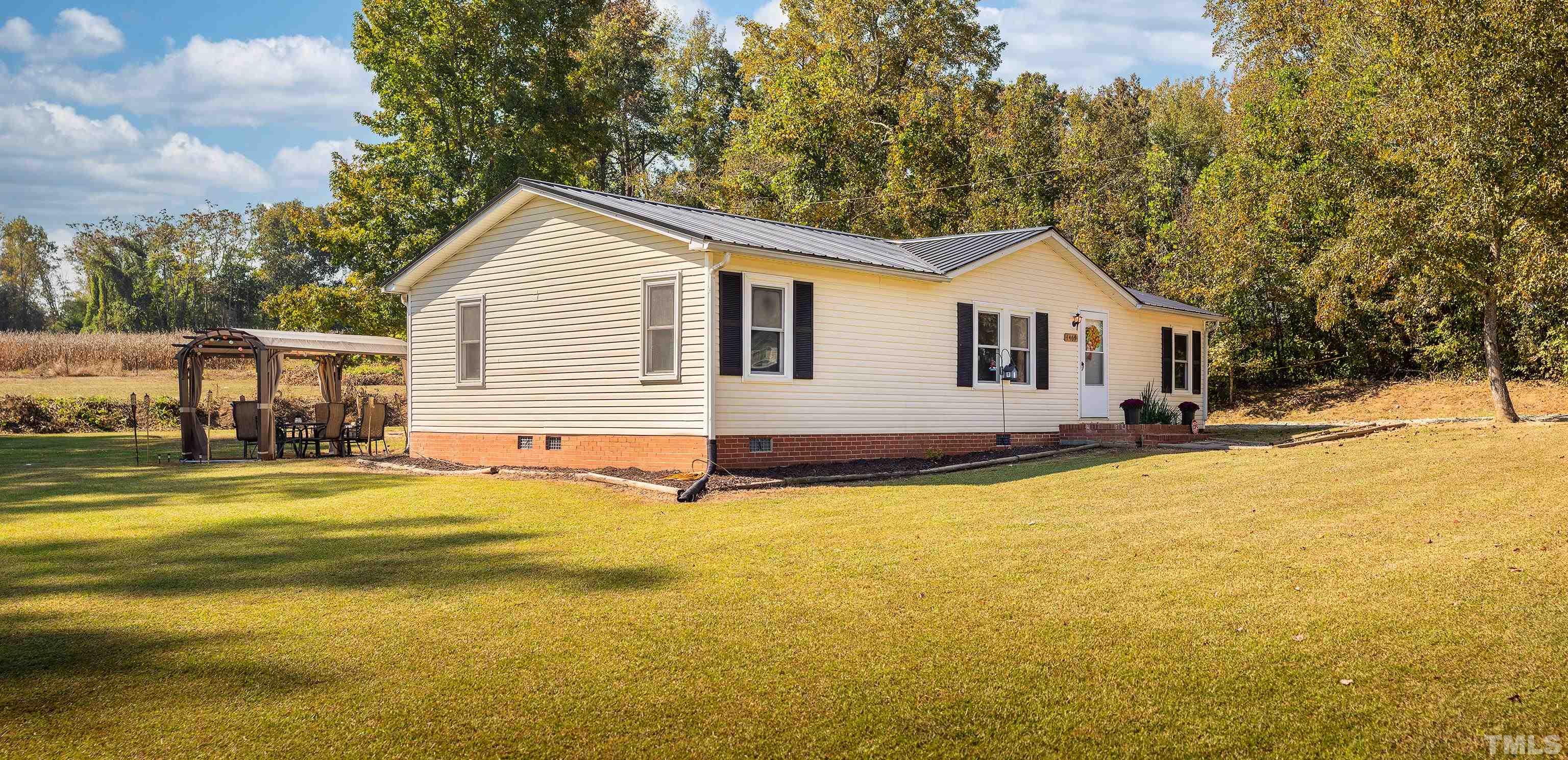 1469 Semora Road Roxboro, NC 27574 - Photo 3 of 22 a view of a house with a yard and garage