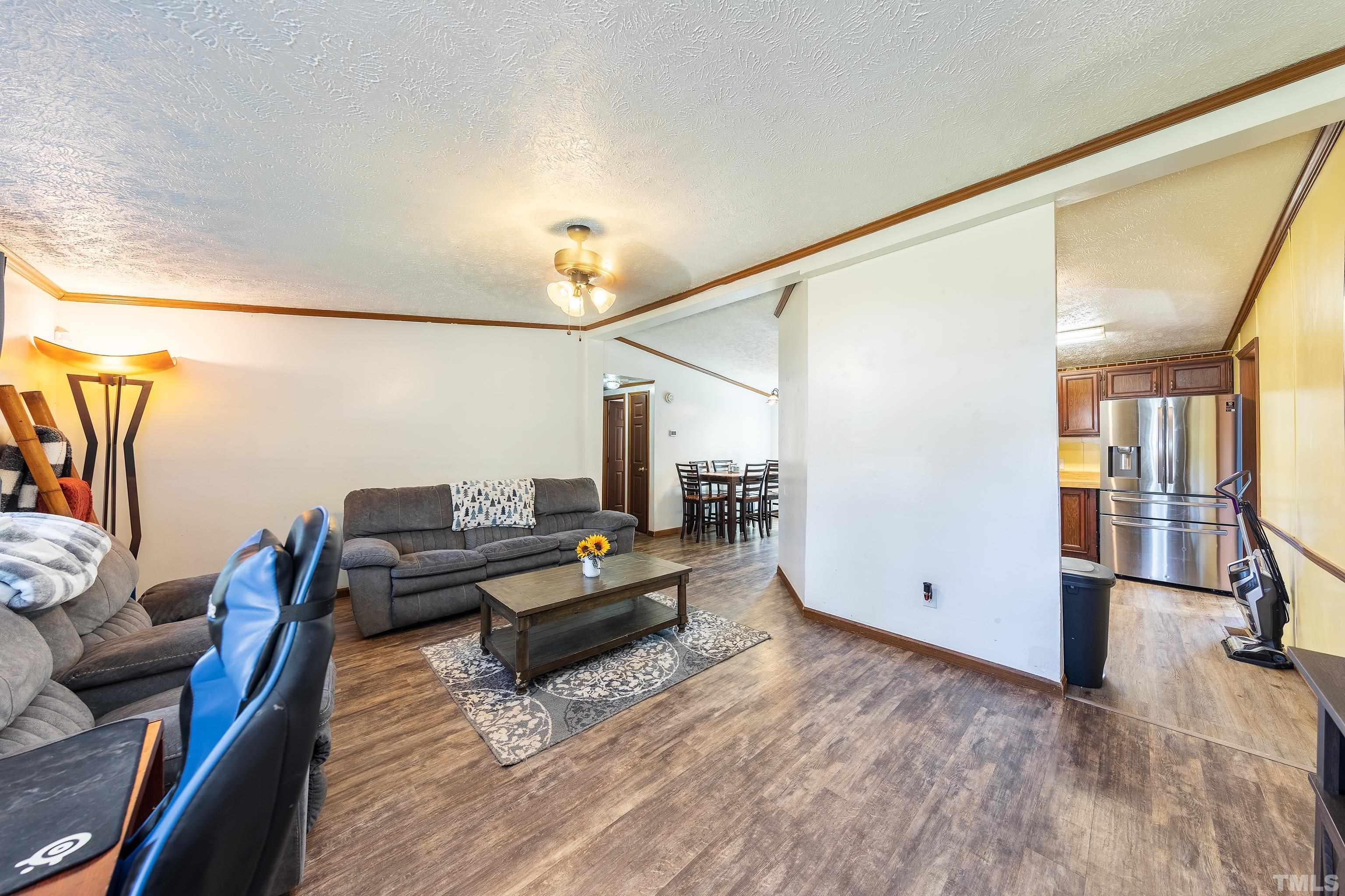1469 Semora Road Roxboro, NC 27574 - Photo 5 of 22 a living room with furniture and wooden floor