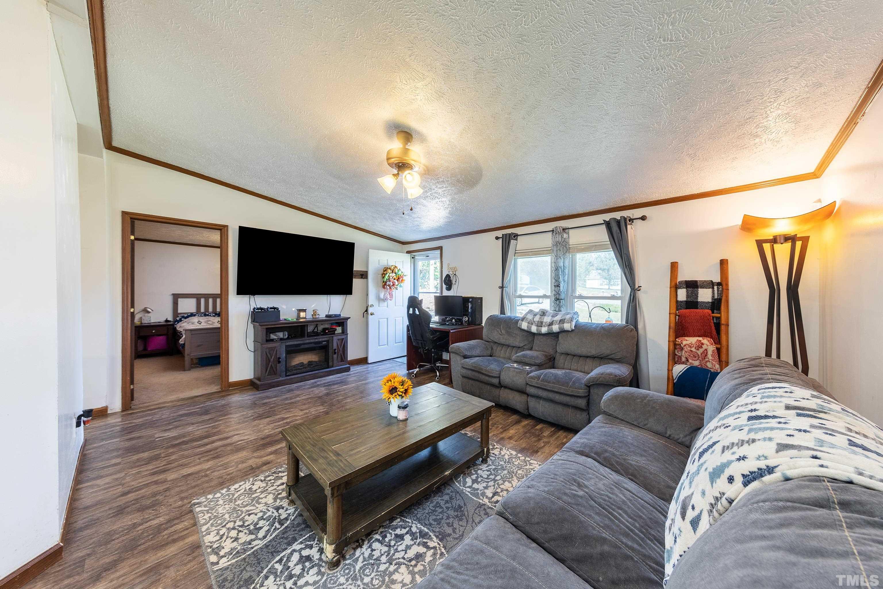 1469 Semora Road Roxboro, NC 27574 - Photo 7 of 22 a living room with furniture and a flat screen tv