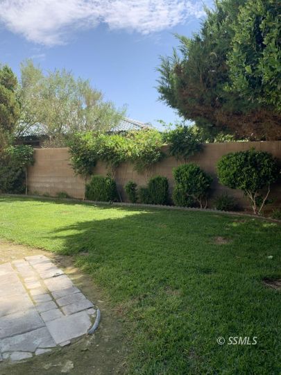 909 Cimarron Court Ridgecrest, CA 93555 - Photo 4 of 6 a view of a lake from a yard