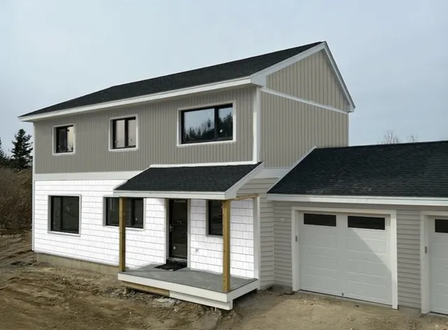 a front view of a house with garage