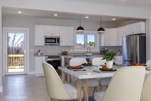 a kitchen with stainless steel appliances granite countertop a stove a sink and a refrigerator