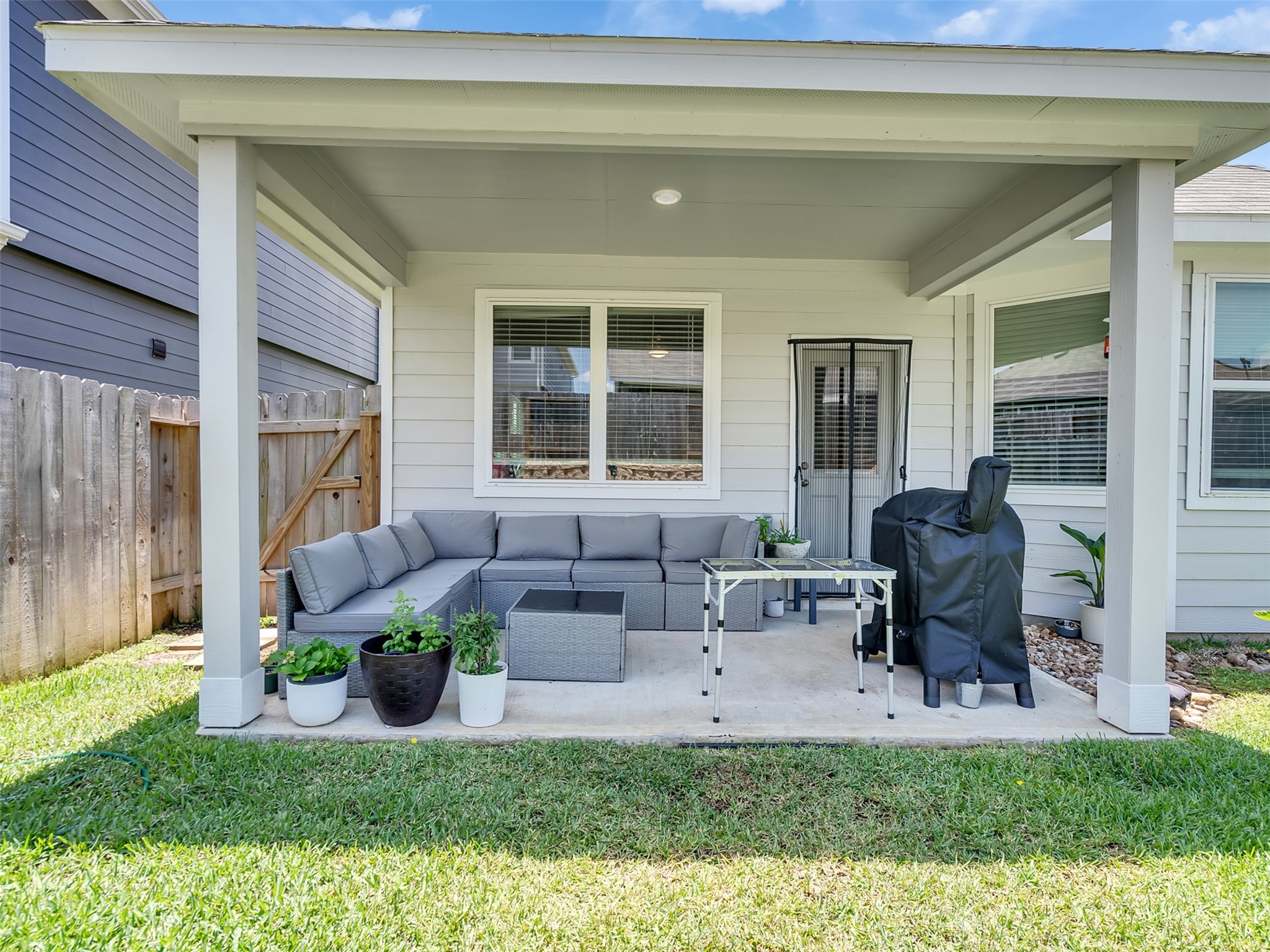 2416 Bluefish Court Conroe, TX 77384 - Photo 16 of 45 a view of a house with backyard sitting area and glass windows