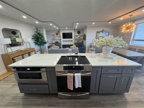 a kitchen with a stove and a white wooden cabinets