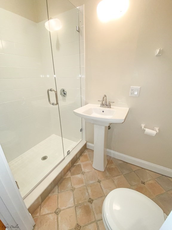 53 Thomas Park, Unit 9 Boston, MA 02127 - Photo 23 of 41 a bathroom with a sink a mirror and a bath tub